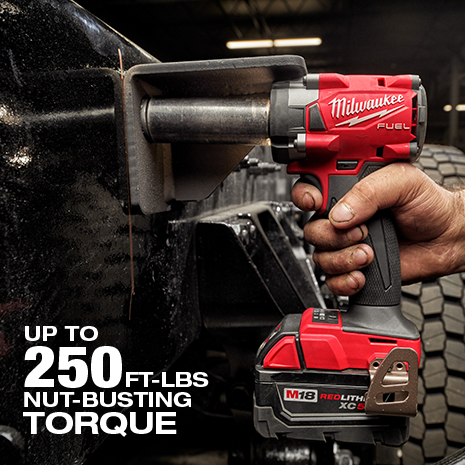 Man uses up to 250 ft-lbs of nut busting torque on vehicle with the Milwaukee compact impact wrench.