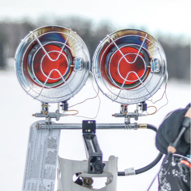 A double burner Tank Top Heater next to a person ice fishing