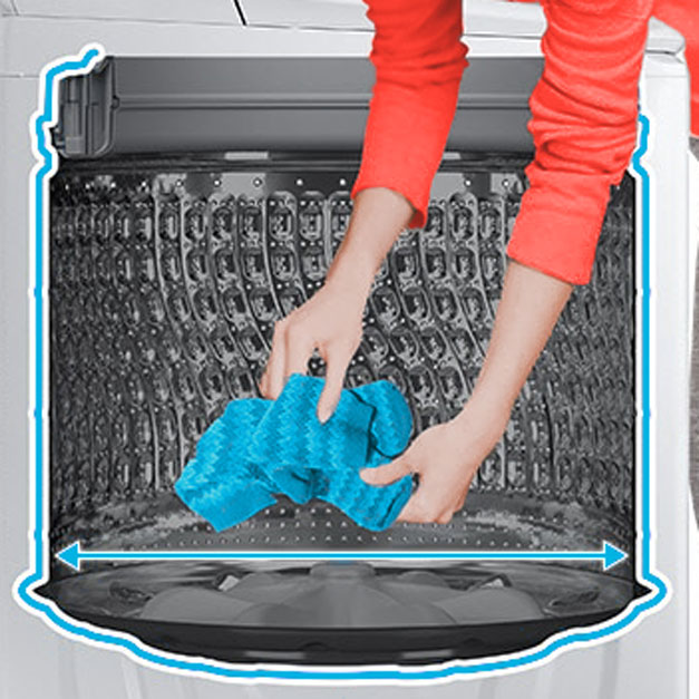 Person reaching into washer to pick up clothes from bottom