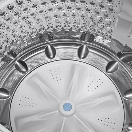 Close-up of front-load washer drum interior with arrows indicating drum pattern for efficiency.