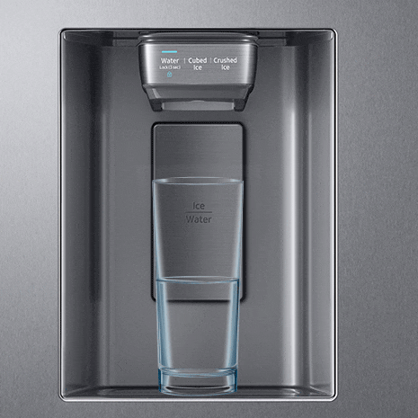 Blue water droplets fill up glass sitting under dispenser
