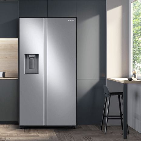 Photo shows refrigerator in a modern kitchen with cabinetry and backsplash