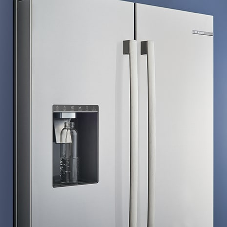 Angled Bosch Refrigerator with Bottle sitting on ice and water dispenser
