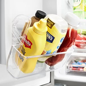 Easily move condiments with the removable condiment caddy.