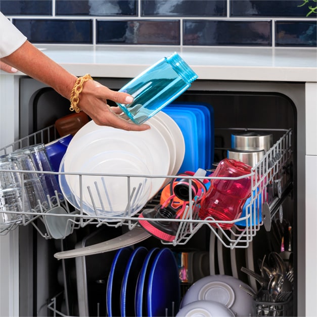 Hand pulling clean and dry plastic cup out of dishwasher