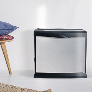 AIRCARE silver Valiant evaporative humidifier against a white wall
