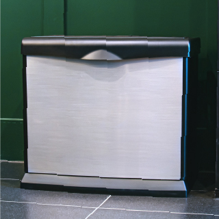 AIRCARE silver Valiant evaporative humidifier against a green wall