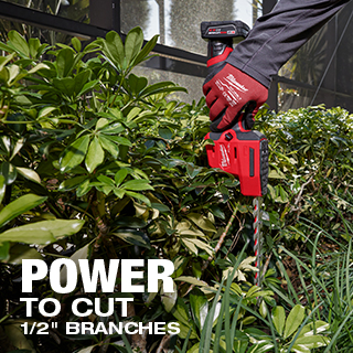 Worker using the M12 FUEL 8 Inch Hedge Trimmer to cut 1/2 inch branches