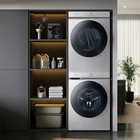 Stacked washer and dryer tucked away in laundry room.