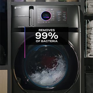 A front-facing shot of an ongoing wash cycle. A caption in the image reads "Removes 99% of Bacteria"