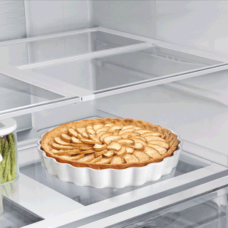 Gif showing slide-in shelf functionality, with shelf sliding in to allow taller items in fridge.