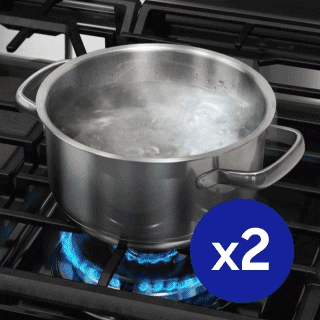 Pot of boiling water on gas cooktop with 