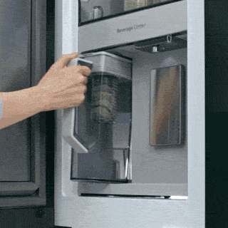 Image of a glass getting water from internal dispenser.