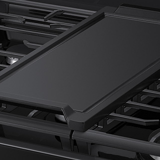 Image of removeable non-stick griddle on gas cooktop.