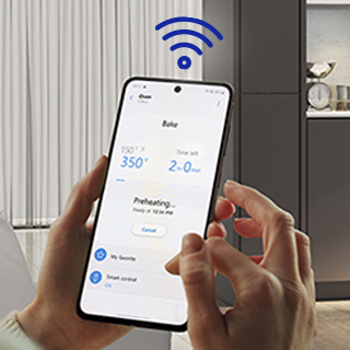 Hands holding phone with screen that shows app controlling oven temperature and wifi icon overlayed.