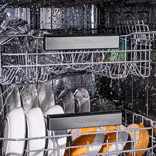 Image of linear wash system in dishwasher, showing water blasts.