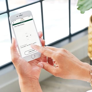 A woman operates the wifi connect app on her phone