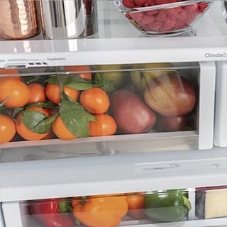 A close-up of the drawer. Fresh fruit is stored inside.