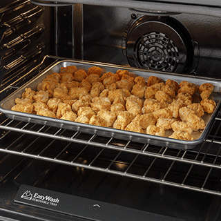 An inside-the-oven view of crispy chicken nuggets that have been air fried.