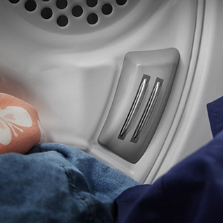 A laundry basket filled with clothes, seen up close.